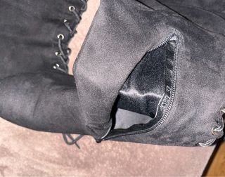 Botas altas negras con cordones.