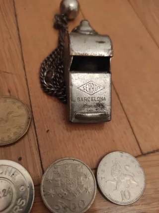 Monedas antiguas y silbato vintage