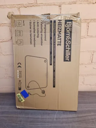 Alfombra calefactora con interruptor de pie.