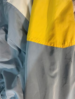 Chaqueta cortavientos azul y amarilla