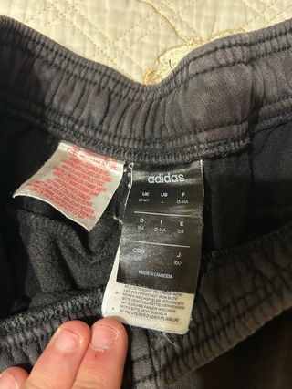 Tuta Adidas nera con bande laterali