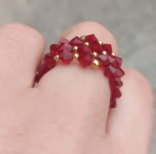 Anello spirale oro giallo 750 con cristalli rossi