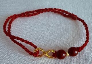 Pulsera tejida mano con infinito dorado