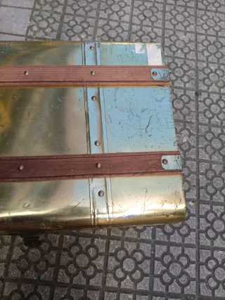 Baúl metálico dorado con detalles de madera