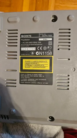 Console PlayStation 1 classica in grigio con due controller e cavo