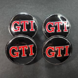 TAPABUJES VW GTI 65mm NEGROS - EMBLEMA VOLKSWAGEN