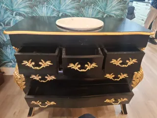 Mueble de baño negro y dorado.