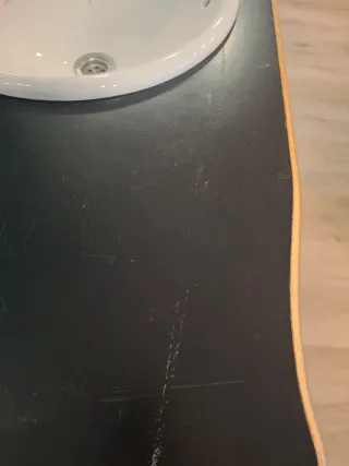 Mueble de baño negro y dorado.