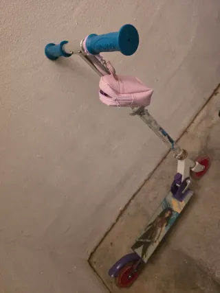 Patinete infantil con bolso rosa.