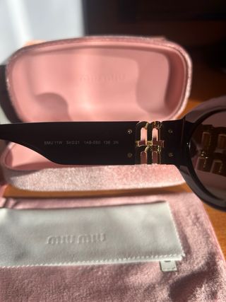 Occhiali da sole Miu Miu neri e oro