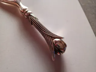 Abridor antiguo forma flor plateado