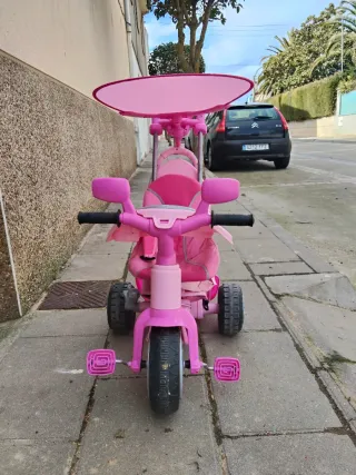 Triciclo infantil rosa con empujador
