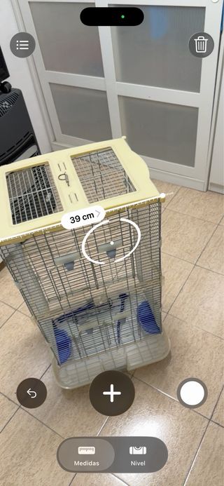 Jaula para pájaros beige y transparente