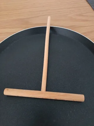 Sartén para crepes con utensilio de madera.