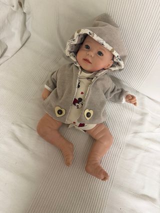 Muñeco bebé con abrigo gris