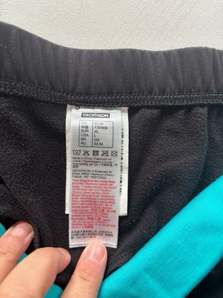 Pantalone da spinning nero con banda turchese