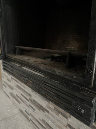 Estufa de leña con ventilación forzada empotrada.