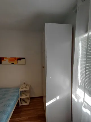 Cama y armario de habitación.