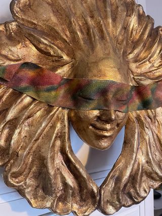 Pannello decorativo dorato volto a forma di sole