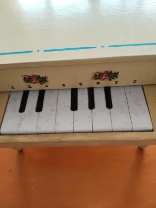 Antiguo piano de juguete con partitura