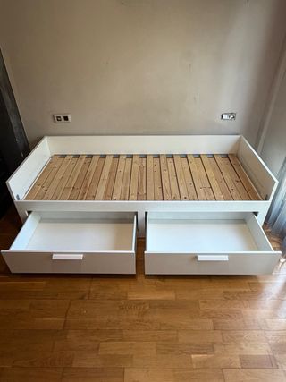 Cama blanca con cajones de madera