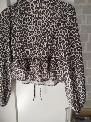 Camisa leopardo con lazada delante.