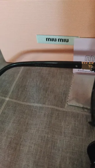 Gafas de sol Miu Miu negras y doradas mujer