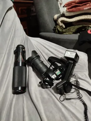 Cámara Nikon F70 con objetivo y flash