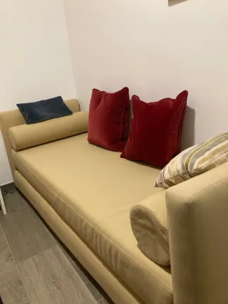 Sofá cama beige con cojines