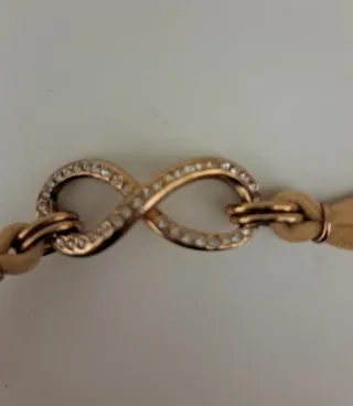 Bracciale infinito beige oro zirconi