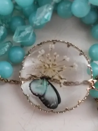 Collana pendente tondo fiori farfalla