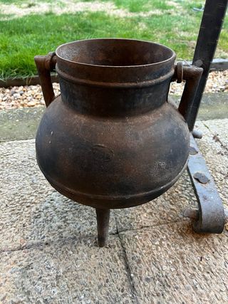 Olla antigua de hierro fundido con soporte