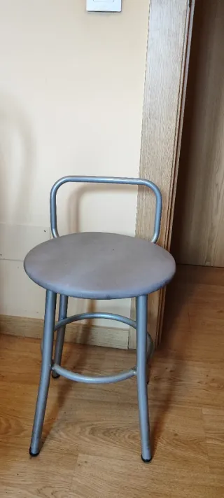 Sillas de cocina plateadas y mesa redonda blanca