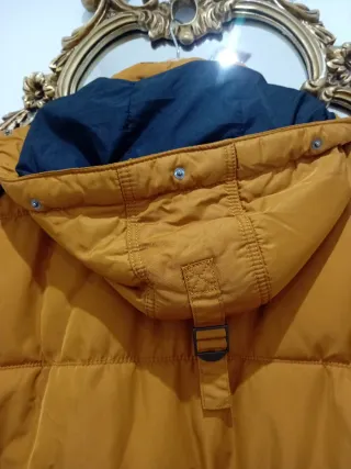 Plumífero caballero naranja y negro