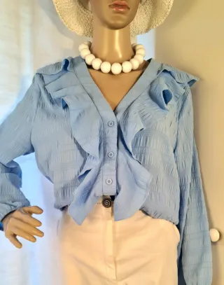 Blusa azzurra con volant
