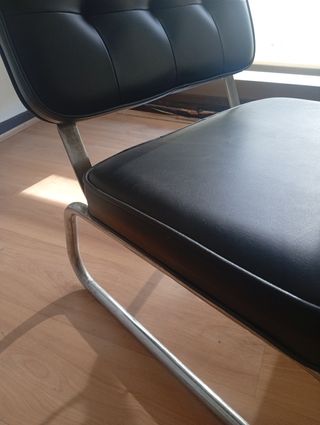 Silla descalzadora negra y acero.