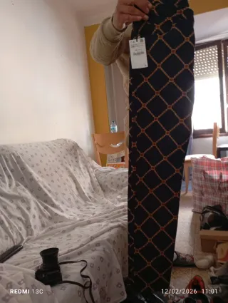 Pantalones negros con estampado de cadenas doradas