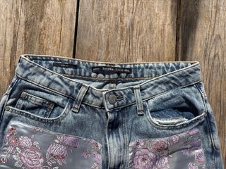 Pantalón vaquero con estampado floral