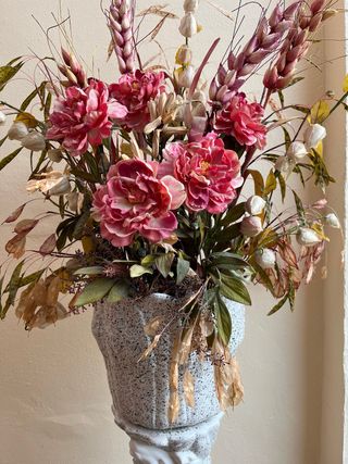 Jarrón con flores artificiales y columna