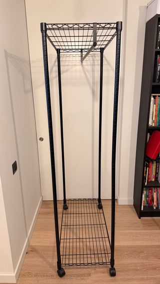 Perchero metálico industrial con ruedas y baldas.