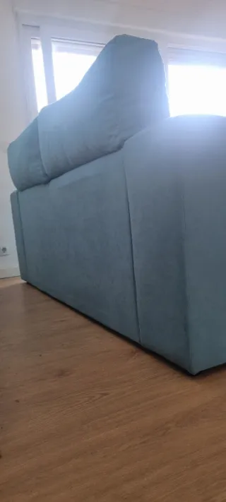 Sofá de tela azul turquesa.