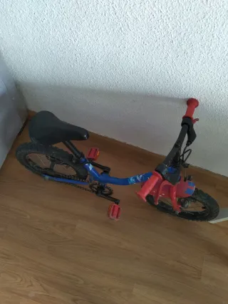 Bicicleta infantil azul y roja con pedales