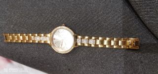 Reloj de oro para mujer con detalles brillantes