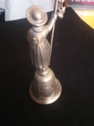 Campana de metal con figura