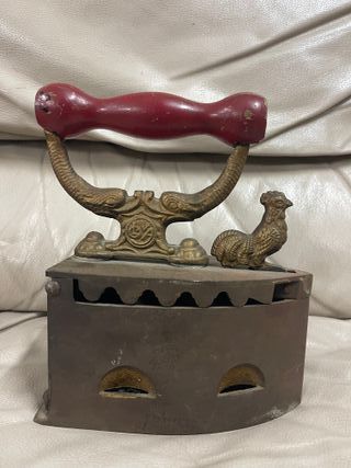 Plancha antigua de carbón en hierro con mango rojo