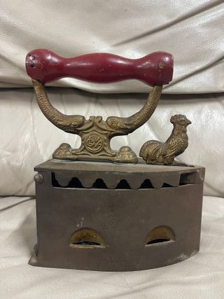 Plancha antigua de carbón en hierro con mango rojo