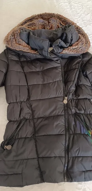 Chaqueta negra con capucha y forro, gorro de pelo.