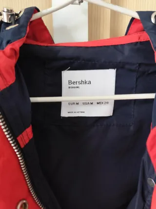 Cortavientos con capucha azul y rojo