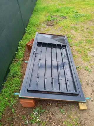 Puerta de hierro con rejas y contra ventana