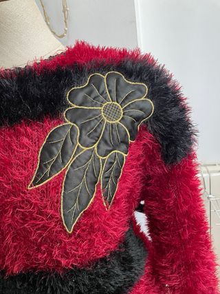 Jersey de punto rojo y negro con flor
